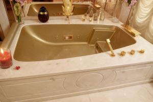 a large bath tub with candles in a bathroom at NEW ÉTOILE Arc de Triomphe renovated March 24 in Paris +42 photos