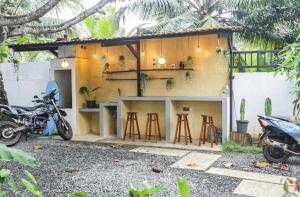 a house with a motorcycle parked in front of it at Cactus reef in Ahangama