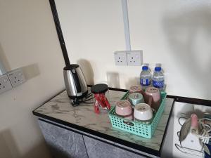 a counter top with a basket of food and drinks at Dongorit Cabin 2 in Kundasang