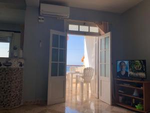 a kitchen with a door open to a dining room with a table at Appartement en bord de mer 3 chambres in Aguemoun Taïda