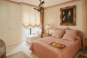 a bedroom with a bed with a tray of food on it at 21a Maréchal FOCH Avenue Paris CHAMPS-ELYSÉES in Paris