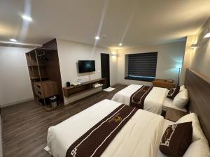 Ένα ή περισσότερα κρεβάτια σε δωμάτιο στο Aurora Đồng Văn Boutique Hotel