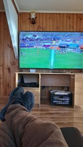 a person laying on the floor in front of a television at Casa Copa de Agua in De Cauquenes