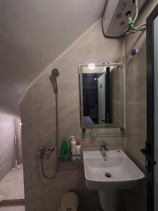 a bathroom with a sink and a mirror at Studio 2 Byhomelinh Phố Cổ Hoàn Kiếm in Hanoi +5 photos