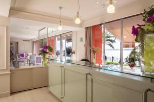 a room with a counter with a view of the ocean at Hotel Suisse in Nice