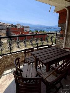 a wooden table and chairs on a balcony at Appartement en bord de mer 3 chambres in Tizouiar