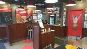 a fast food restaurant with a counter and a bar at Victoria Motor Inn in Niagara Falls