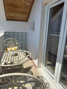 a patio table and chairs on a balcony at House of Mimoza in Shkodër +46 photos