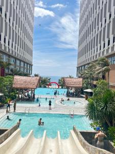 a large swimming pool in a city with people in it at Apec mandala Apartment - APEC Mandala Ocean View Mũi né-R0234 in Mui Ne +56 photos