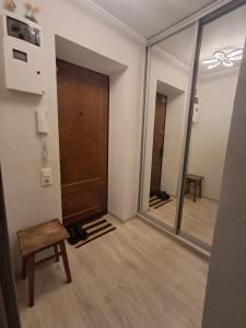 a hallway with a door and a chair and a mirror at Apartment on Parusna, 2 in Chornomorsk +3 photos