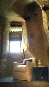 a living room with a white couch and a window at SOTA Cappadocia in Ürgüp