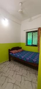 a bedroom with a bed and a window at Luiza Guest House in Baga