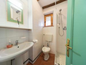a bathroom with a sink and a toilet at Rustic Chalet with Pool in San Marcello Pistoiese +32 photos