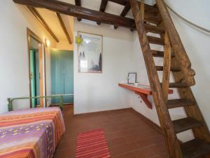 a room with a wooden staircase and a bed at Rustic Chalet with Pool in San Marcello Pistoiese