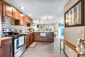 a large kitchen with wooden cabinets and appliances at Charming Cottage by Creek & Ocean in Blaine +29 photos