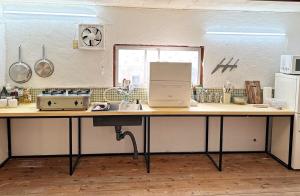 a kitchen with a counter top with a sink at オワセベースowase base in Owase