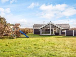 a house with a yard with a playground at 8 person holiday home in Harboøre-By Traum in Harboør