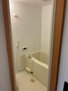 a bathroom with a bath tub and a sink at Guesthouse & Kitchen Hace - Vacation STAY 68911v in Iwaki