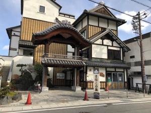 a building with an asian inspired architecture on a street at Guesthouse & Kitchen Hace - Vacation STAY 68911v in Iwaki