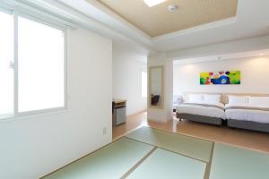 Postel nebo postele na pokoji v ubytování Beppu Daiiti Hotel