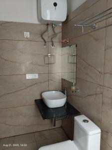 a bathroom with a toilet and a bowl on a counter at Hotel Swastik Inn in Gangtok