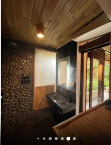 a bathroom with a sink and a mirror at Gaia Retreat Center in Ubud +14 photos