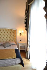 Postel nebo postele na pokoji v ubytování Agriturismo De Luca