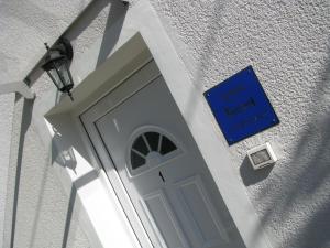 a door to a building with a blue sign on it at Apartment Sea Garden in Ičići