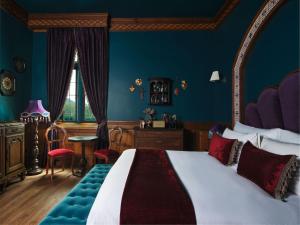a bedroom with a large bed and blue walls at Maison Mystique Khao Yai in Mu Si +112 photos