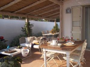 a patio with a table and chairs on a patio at Villa Mare Di Montelusa in Agrigento