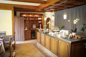 a large kitchen with a counter with food on it at Hotel Rosenhof Garni in Pegnitz