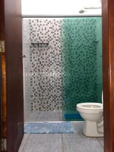 un bagno con doccia in vetro e WC di Pousada Corazao Sagradao ad Abadiânia
