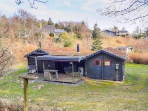 a small house with a porch on a field at 6 person holiday home in Spøttrup-By Traum in Lihme