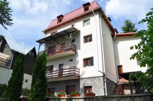 um edifício branco com um telhado vermelho em Vila Felix em Sinaia