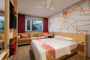 a bedroom with a bed and a wall with a map at Ginger Thane in Thane +57 photos