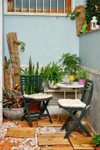 a patio with two chairs and a table and plants at Central Garden Saldanha Apartment in Lisbon