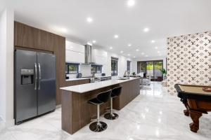 a kitchen with a island and a pool table at Golden Fox Downtown Pool House home in Fort Lauderdale