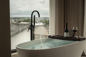 a bath tub in a room with a window at DaLi牧云相框空间侘寂民宿 in Dali Ancient Town +89 photos