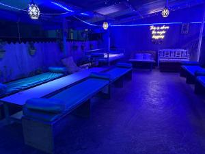 a room with blue lights and couches and tables at LA SIESTA INDIA MCLEODGANJ in McLeod Ganj