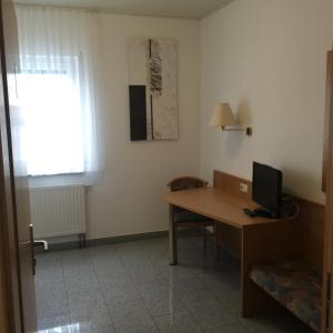 Zimmer mit einem Schreibtisch und einem Computer darauf in der Unterkunft Gasthaus Keglerklause in Schwieberdingen