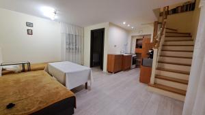 a room with a bed and a staircase in it at Dom przy Lawendowej Altanie in Kosow
