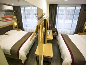 Кровать или кровати в номере Thank Inn Plus Hotel Hubei Yichang Free Trade Area Fazhan Avenue