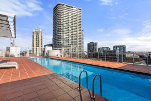 a swimming pool on the roof of a building at 72-1HS Abnb-Style GardenView, Parking, Balcony, Step to Chinatown and QVB in Sydney