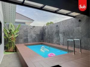 a swimming pool in the middle of a house at Family Pool Villa, BBQ with Warm Welcome in Ban Nok