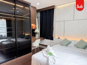 a hotel room with two beds and a chair at Family Pool Villa, BBQ with Warm Welcome in Ban Nok