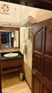 a bathroom with a sink and a mirror at Hotel Mandawa Vilas in Mandāwa +128 photos