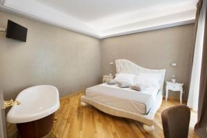 a bedroom with a white bed and a sink at Appartamenti Trapani In in Trapani