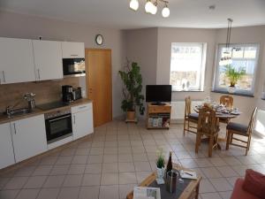 a kitchen and living room with a table and chairs at Romantischer Aufenthalt mit Blick auf den Weinberg in Kinheim