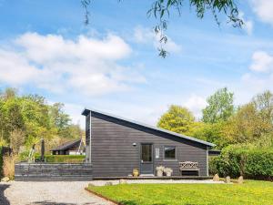 a small house with a black roof at 6 person holiday home in Bjert-By Traum in Sønder Bjert