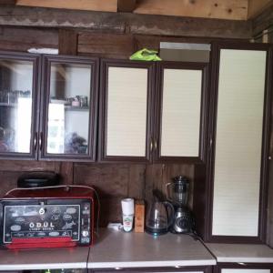 a kitchen with wooden cabinets and a counter top with a microwave at Gomismta Panorama in Gomi
